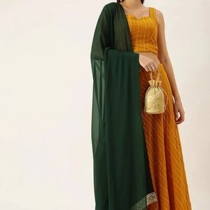 Mustard lehenga set with dark green dupatta and golden detailing